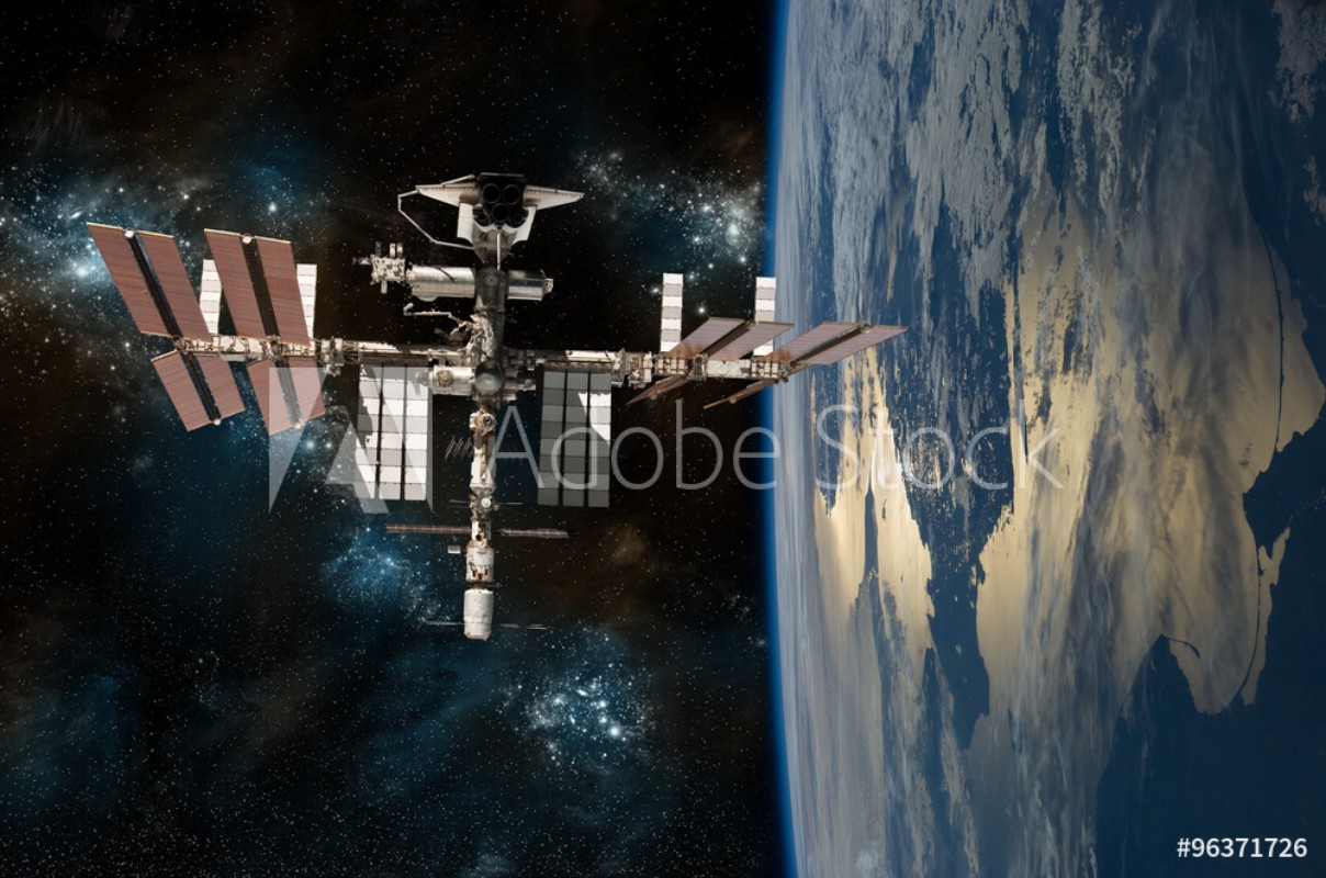 Bild på The International Space Station Orbiting Earth with the space shuttle docked -  - Elements of this Image Furnished by NASA